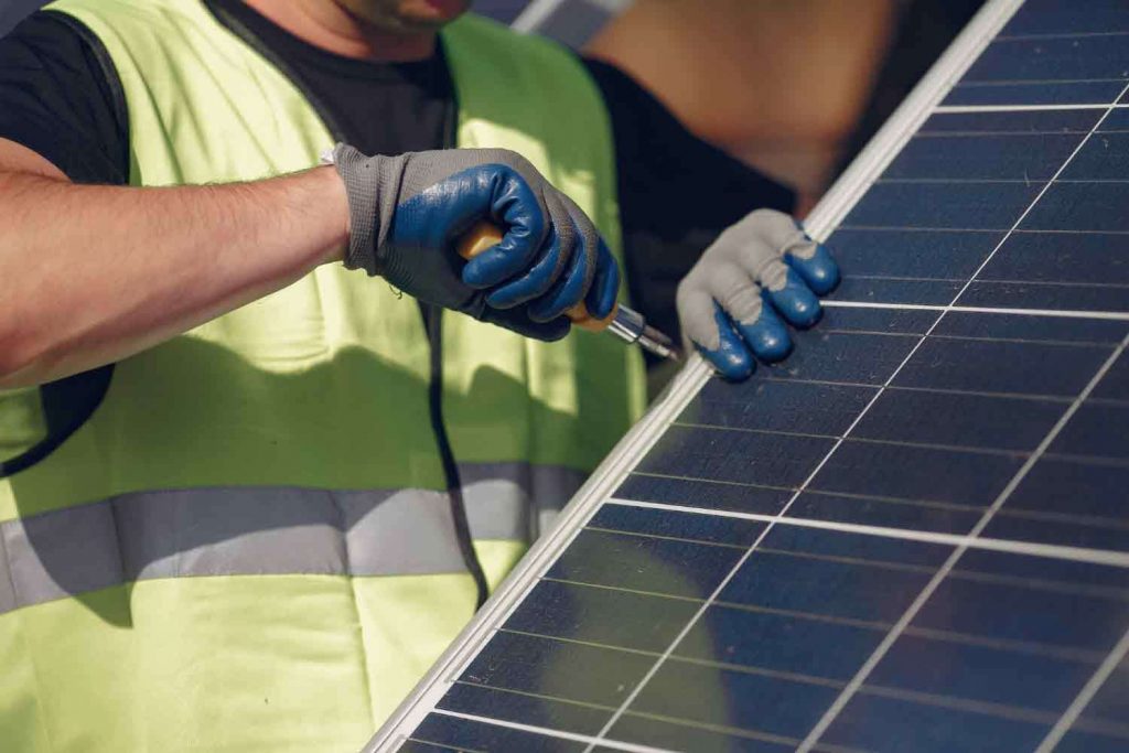 Installer Installing A Solar Panel On A UK Home